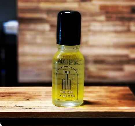 Bottle of Oudel London oil on a wooden surface with a blurred background
